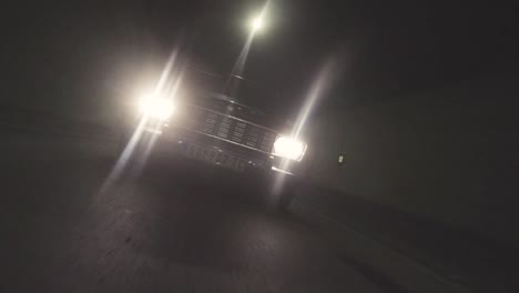 car driving through a night tunnel