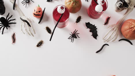 video of halloween drinks and decorations with copy space on white background