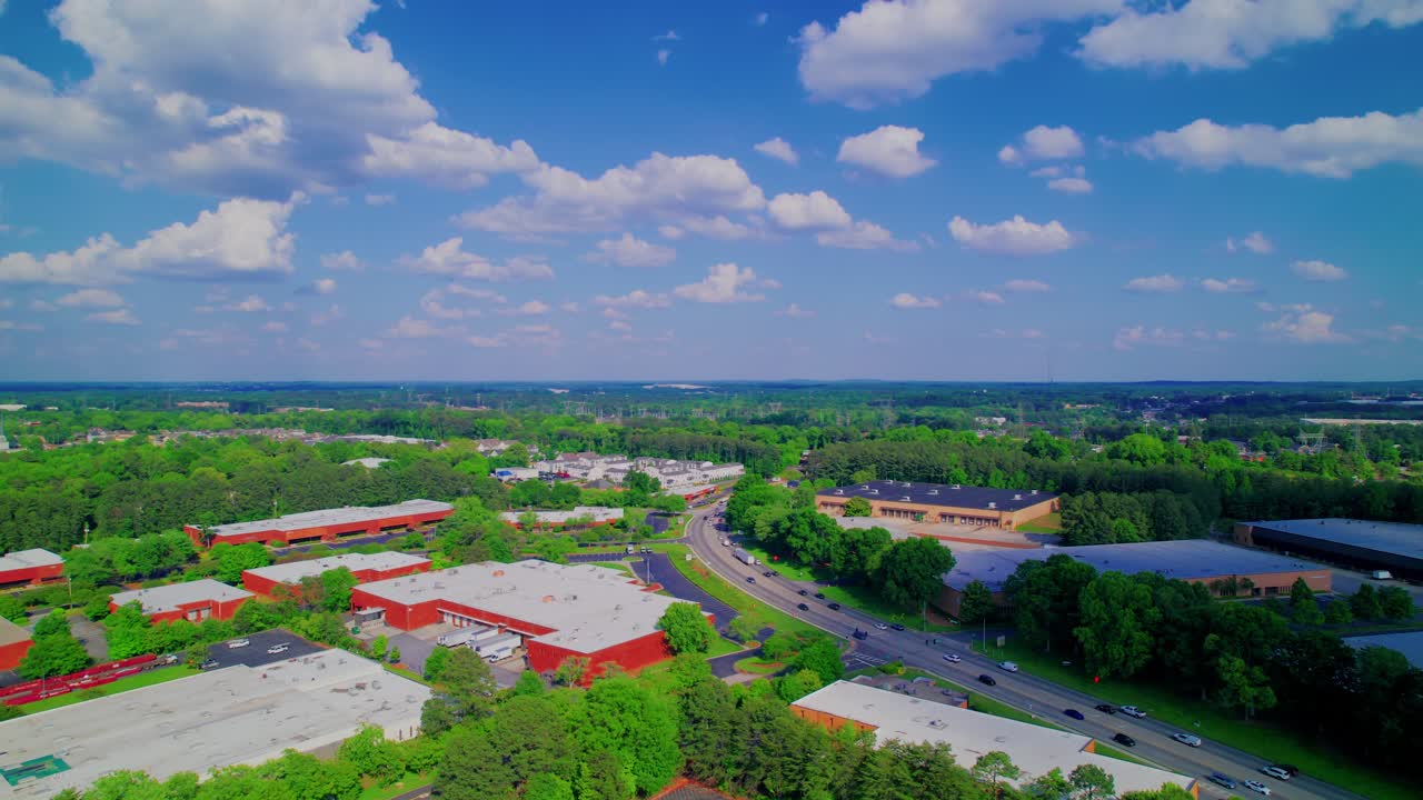 Norcross, Georgia's dynamic commercial landscape, business parks and infrastructure with expansive green spaces under a clear sky.