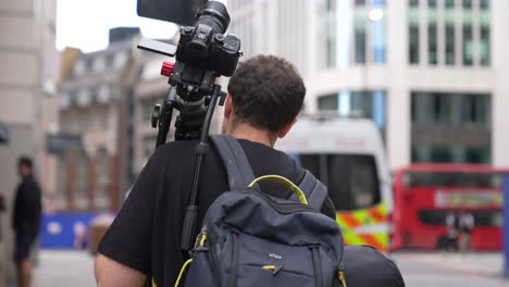 videographer walking through london on his way to get footage