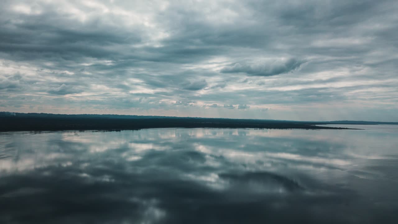Serene Lake Reflection Under a Dramatic Sky