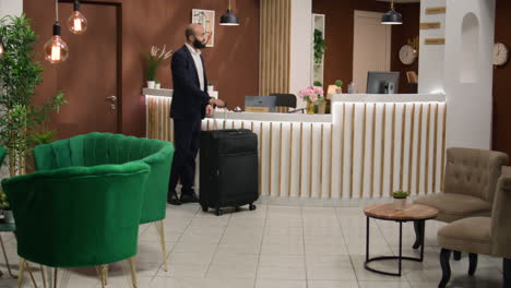 entrepreneur arriving at hotel reception