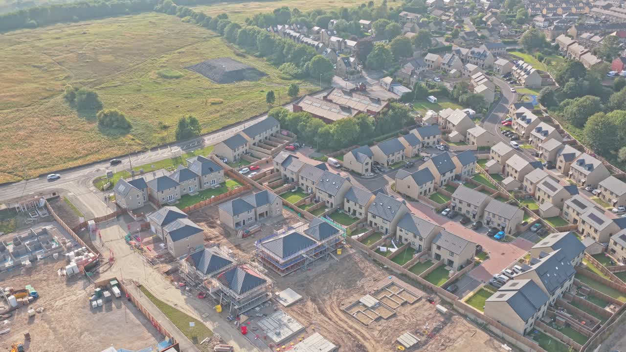 Sunderland Way, Lightcliffe, Brighouse, West Yorkshire, England shows modern homes, estate layout, and construction beside open fields and woodland, on residential road near Brighouse and Hipperholme