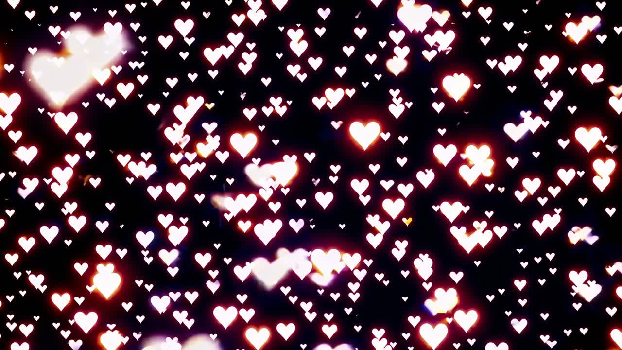 Heart-shaped bokeh lights create a mesmerizing visual effect, transitioning through various sizes and intensities, enhancing the romantic atmosphere in a continuous motion sequence
