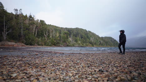 lonely and frustrated person walking and releasing tension on empty rocky beach