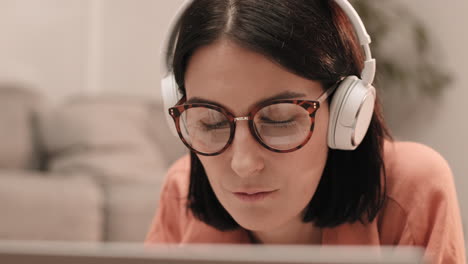 young woman wearing glasses and headphones