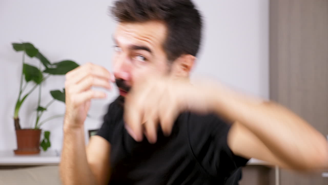 A man expressing sadness and anxiety indoors