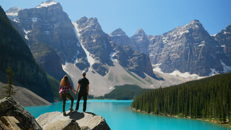 Couple-standing-on-a-rock-near-riverside-4k