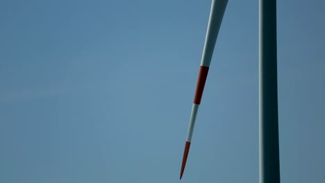 Closeup-slow-rotating-Wind-turbine-with-blue-sky-background-concept-green-energy