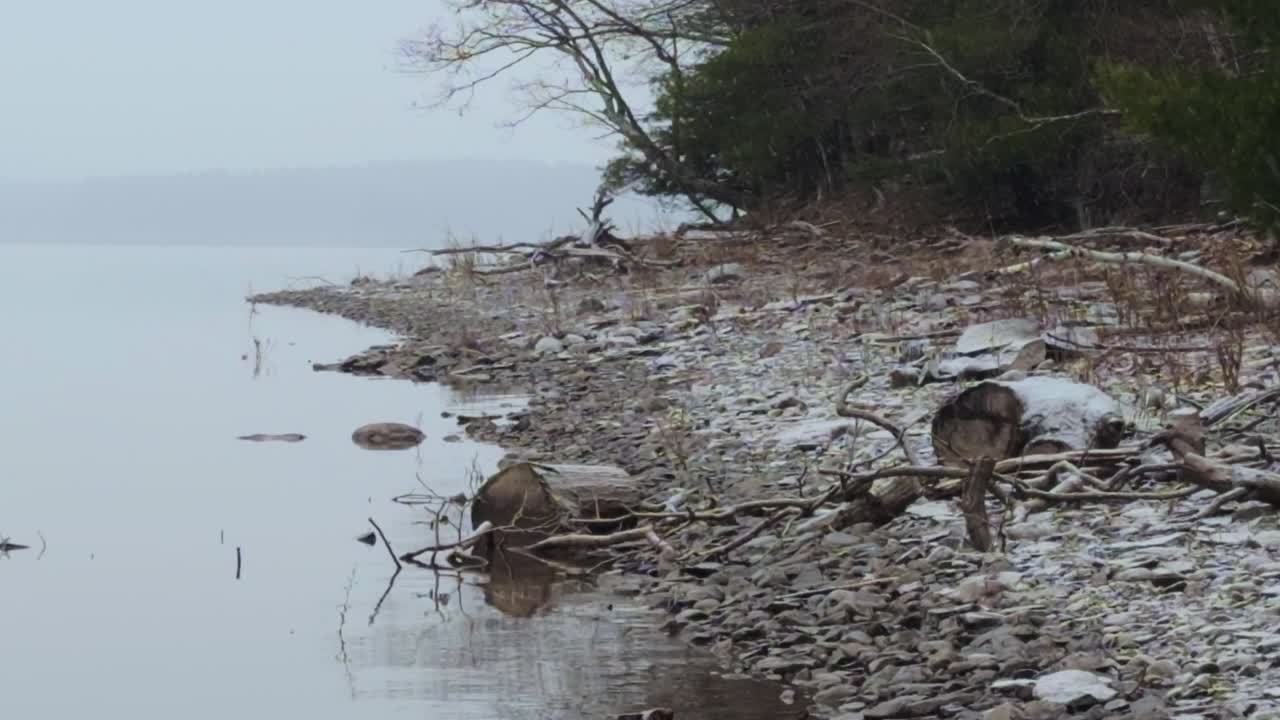 light, gentle snowfall on a beautiful, peaceful mountain lake, during a nor'easter, in the Appalachian mountains