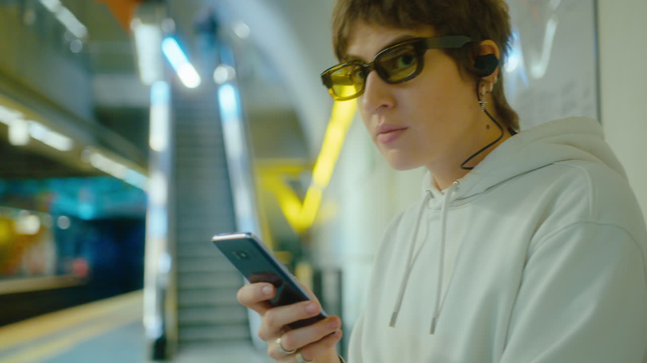 Girl Sitting in Subway and Scrolling on Smartphone
