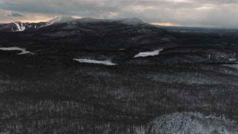 panoramic view of a winter forest and mountains during sunset in orford, quebec, canada