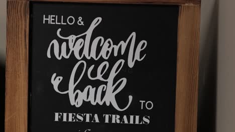 black and white wooden blackboard boarder vintage antique chic modern stylish boho welcome chalkboard retail business front door entryway welcome back to fiesta trails sign