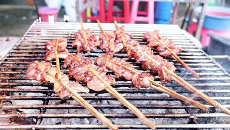 sequential grilling of skewered meat outdoors