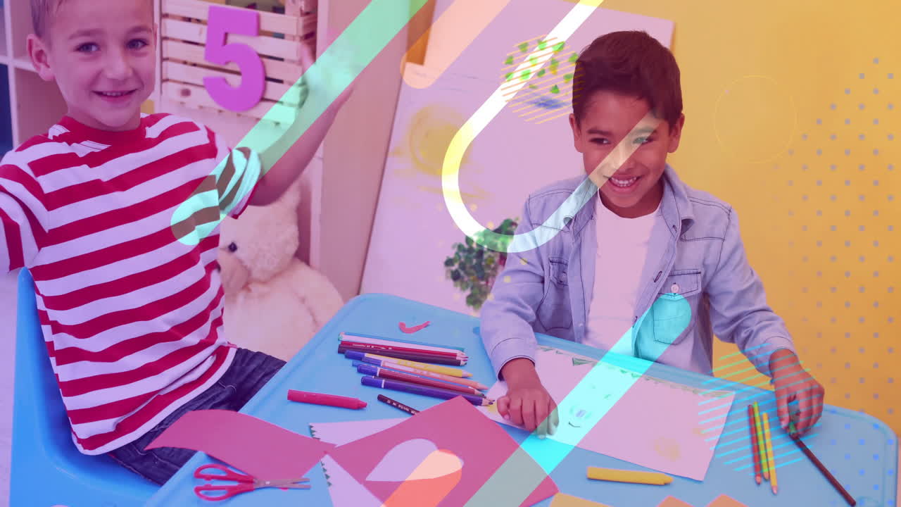 Children drawing and smiling at table, colorful shapes animation over them