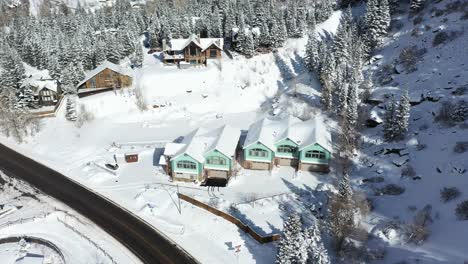 aerial view, wooden houses and cottages in sunny snowy winter landscape of ouray small mountain town in colorado usa