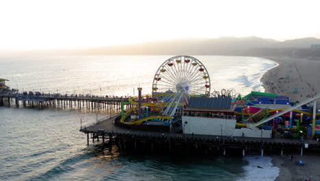 sunset over santa monica pier with ferris wheel and ocean