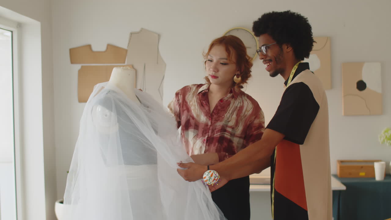 Male Tailor Discussing Wedding Dress Design with Female Client