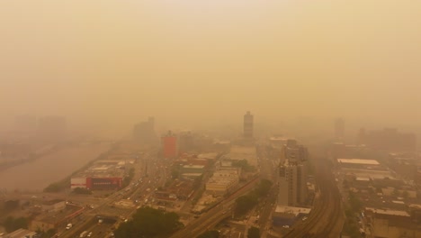 Aerial-view-over-Concourse,-Bronx,-New-York,-covered-in-thick-forest-fire-haze