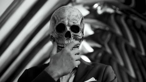 man in skull mask business suit