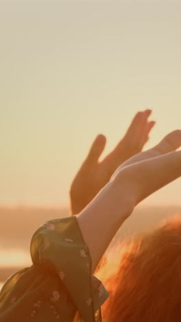 sunset with outstretched hands