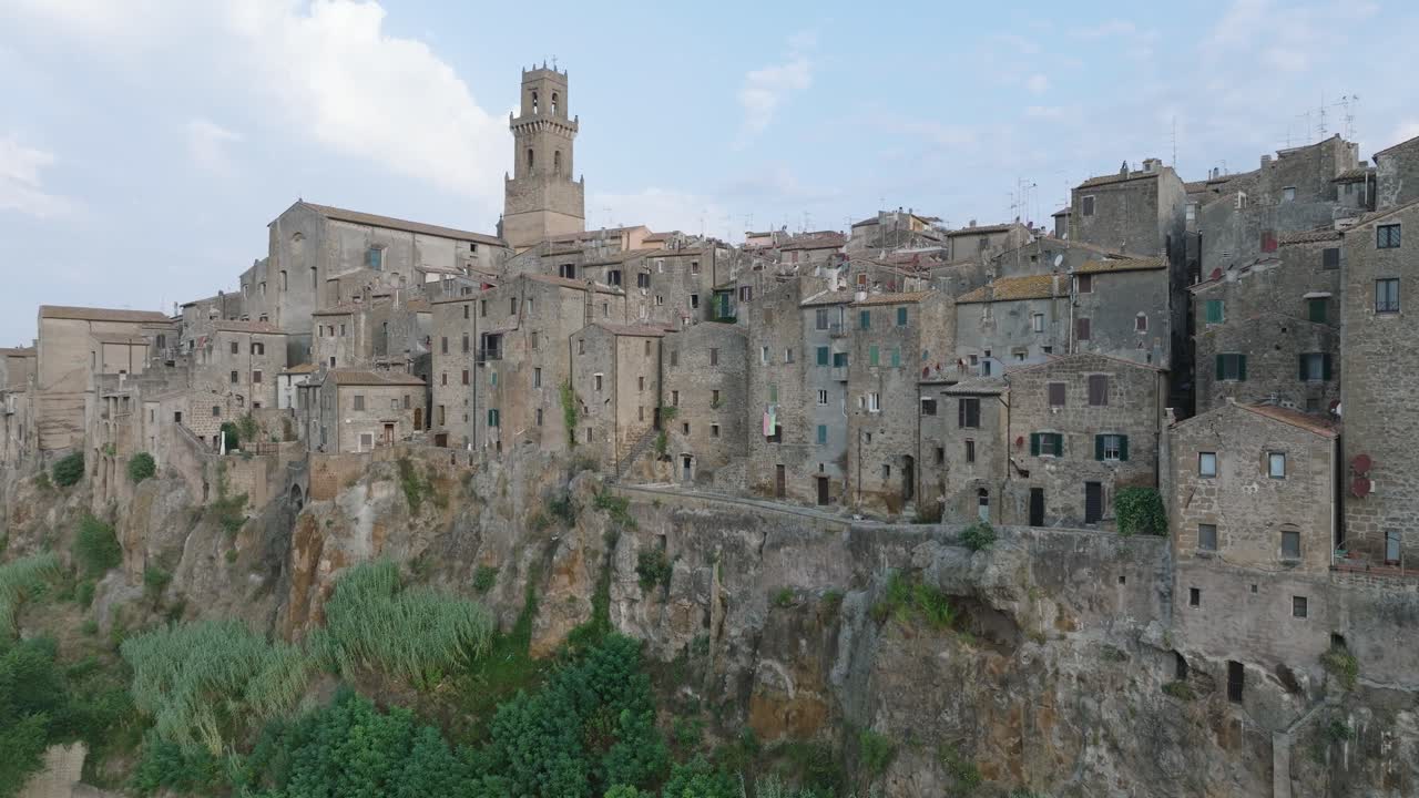 Aerial Drone view of the hilltop Medieval town of Pitigliano, Tuscany in morning light, with the Valdorcia and old buildings, in 4K