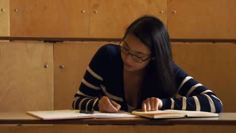 student taking down notes in class