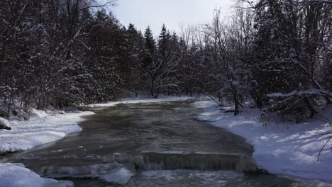 Arroyo-Que-Atraviesa-El-Bosque-En-Invierno-Con-Cascada