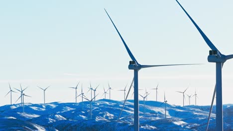 wind farm on snowy terrain with static and dynamic wind turbines