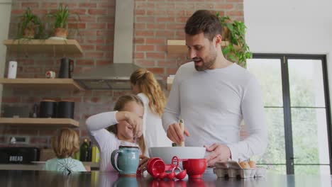 Father-and-daughter-preparing-cookie-on-worktop-in-kitchen-at-home-4k