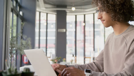 Man-using-laptop-and-mobile-phone-4k