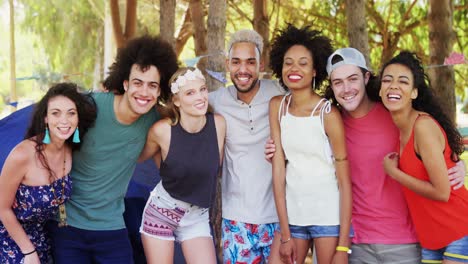 friends standing together with arm around in park 4k