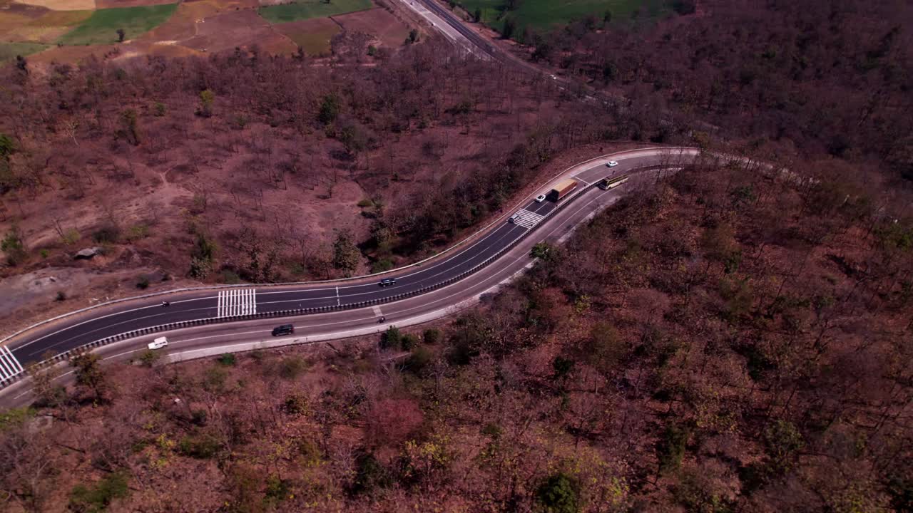 National Highway 34 with agricultural land and vehicles at siluwa, ramanpur, hulki, madhya pradesh, india. day time, push in, tilt down, drone shot, 4k.