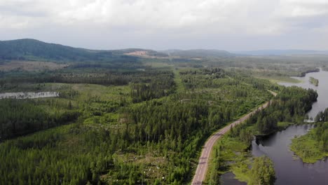 AERIAL---Forest-and-lake-in-the-Arctic-region-of-Sweden,-wide-shot-forward