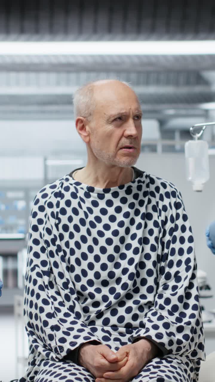 Vertical Video Doctors in hazmat suit monitoring patient vitals during an outbreak