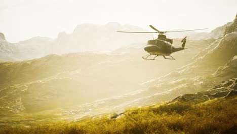 slow motion vietnam war era helicopter in mountains