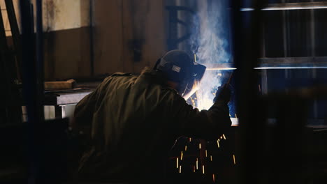 A-welder-in-a-protective-helmet-and-clothes-welds-as-sparks-fly-7