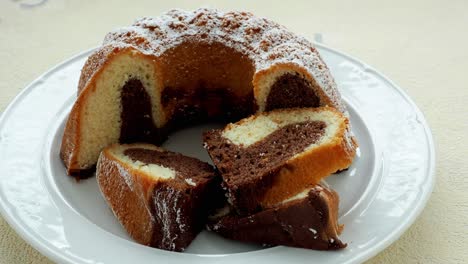 traditional homemade marble cake. sliced marble bundt cake on white plate