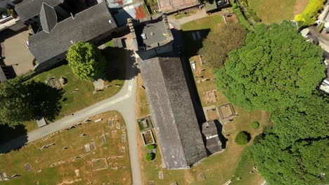 overhead descending aerial video of the church of the holy trinity in carlingford, county louth, ireland on a bright and sunny day. filmed in 4k, 60fps and with rec709 color.
