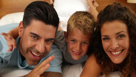 Little-boy-smiling-at-camera-with-parents