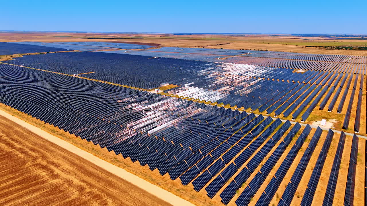 Big solar farm produces energy. Vast expanse of solar panels stretches across fields, capturing sunlight to produce clean energy in an open landscape