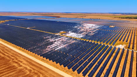 big solar farm produces energy. vast expanse of solar panels stretches across fields, capturing sunlight to produce clean energy in an open landscape