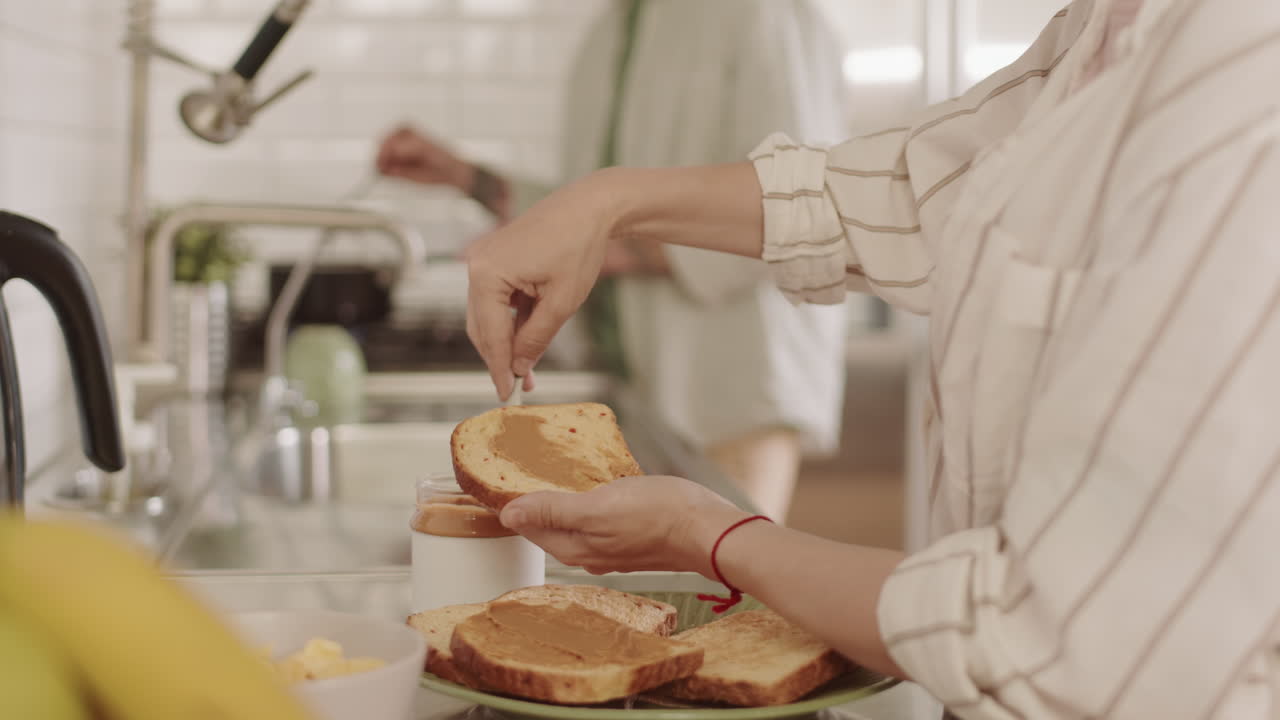 Person Making Toast with Peanut Butter
