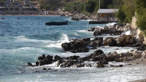 foamy waves of the adriatic sea breaking against the shore of an albanian beach