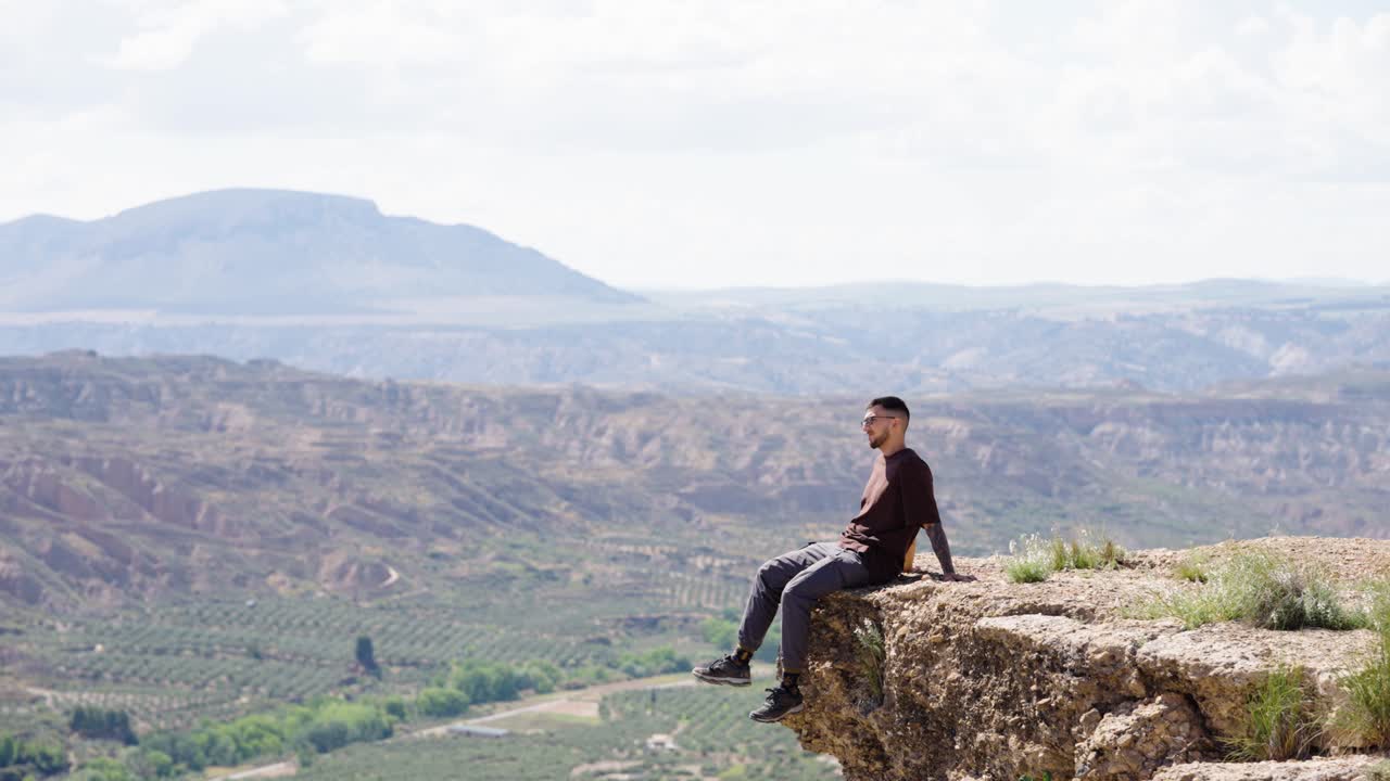 Tourist enjoying the view from a cliff in gorafe, spain