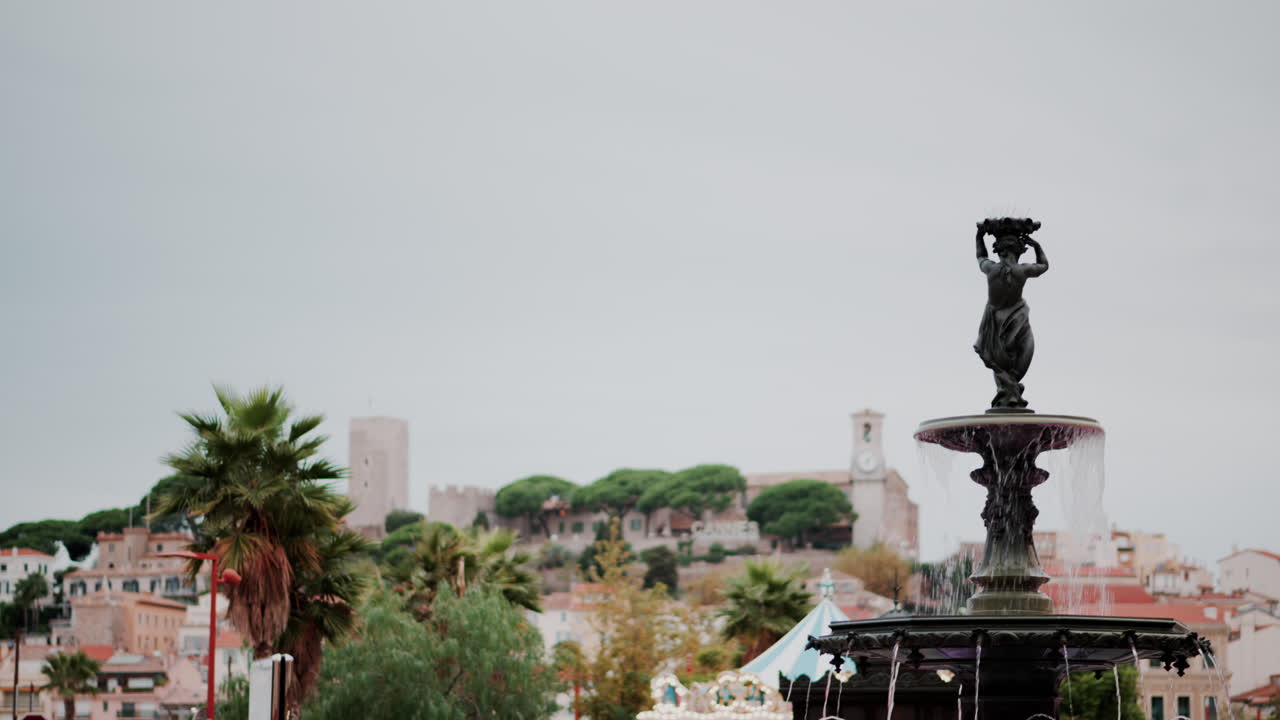 Water pouring in a fountain with a blurry background in Cannes, France