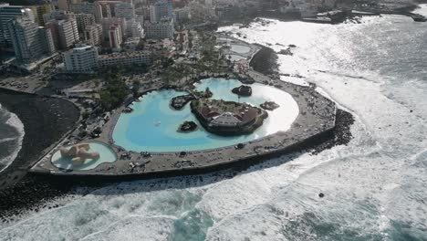 Toma-En-órbita-De-La-Distintiva-Piscina-Lagos-Martianez,-España