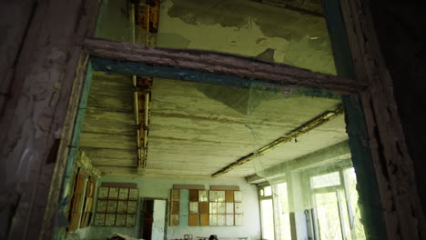 abandoned and destroyed classroom of pripyat elementary school, tilt down