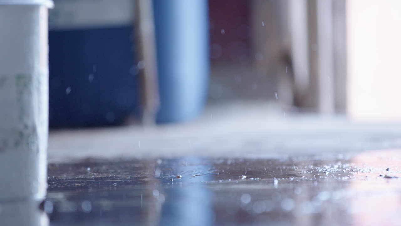 SLOW MOTION - liquid splashing on the floor around rubber boots