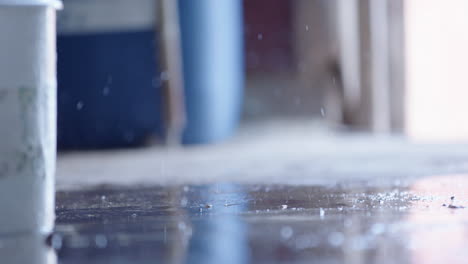 slow motion - liquid splashing on the floor around rubber boots